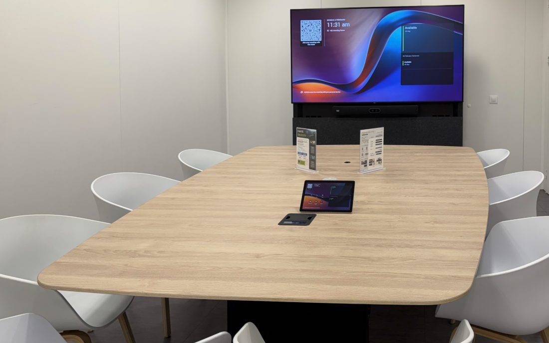 Velocity boardroom with a light wood table and ten seats