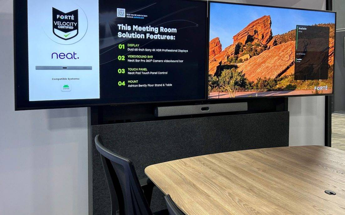 Velocity conference room with dual displays and a table microphone