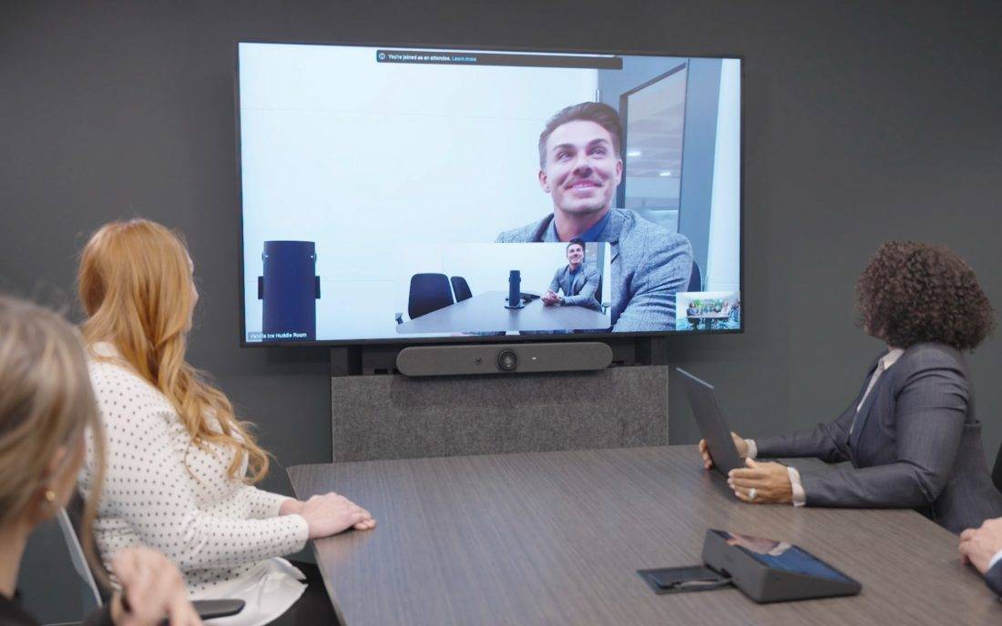 Colleagues on a hybrid call in a Velocity room
