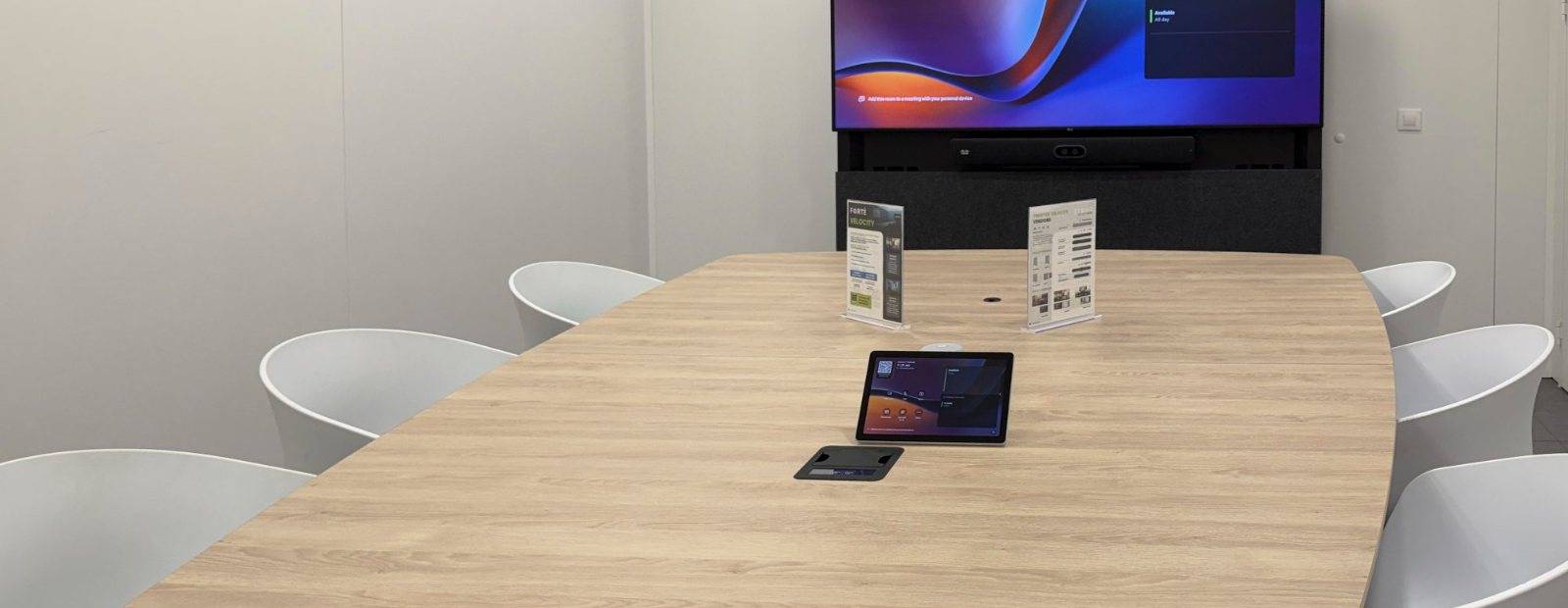 An executive boardroom equipped for hybrid meetings